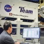 Man controlling vibration test system being used on NASA's James Webb Space Telescope.