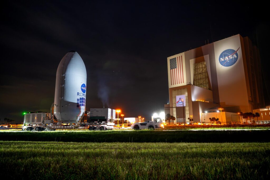 NASA’s Nancy Grace Roman Space Telescope, encapsulated in its payload fairing, travels from the Payload Hazardous Servicing Facility to the SpaceX hangar at Launch Complex 39A at NASA’s Kennedy Space Center on Tuesday, Aug. 25, 2026, ahead of mating to a SpaceX Falcon Heavy rocket.
NASA/Sydney Rohde (Rocz)